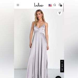 Floor length sleeveless dress with a slit. Color is cream/peach